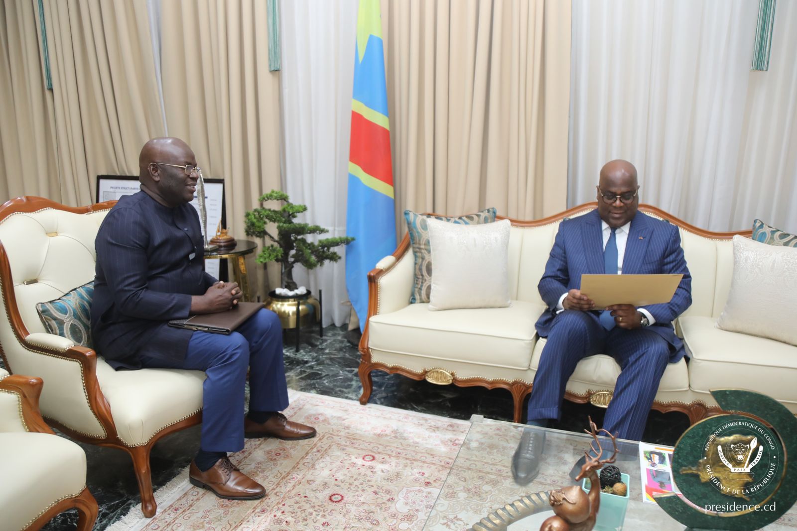 two men sitting on couches in a room